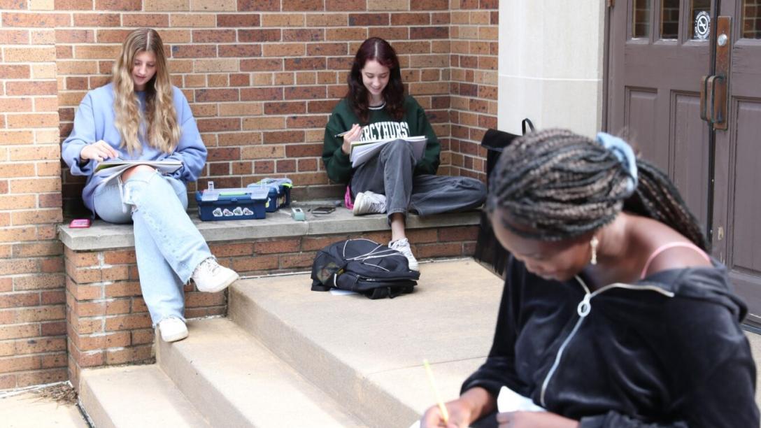 Art students sketching sitting down