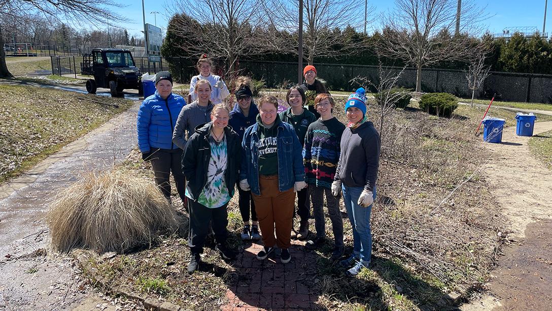 Group posing for a photo for Sennett Institute project outside