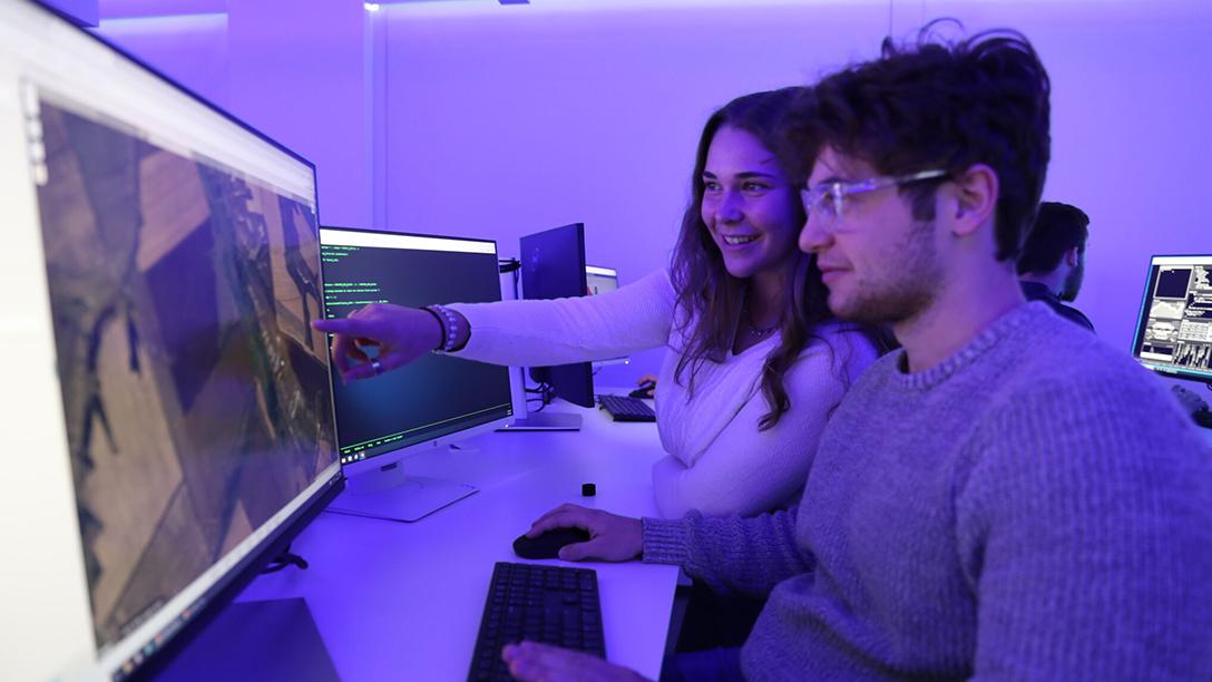 Students pointing at a map on a shared computer in the CIRAT lab