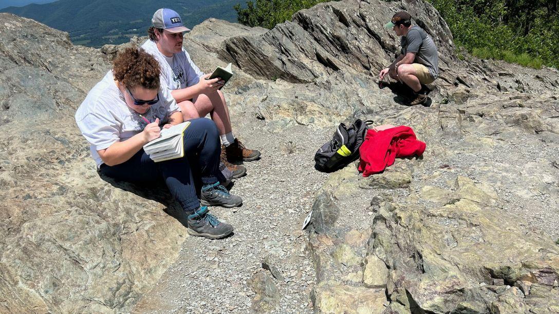 Geology students mountain top landscape
