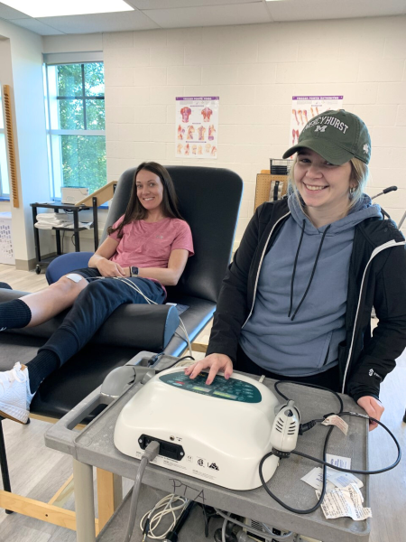 two female physical therapist assistant students pose in a lab