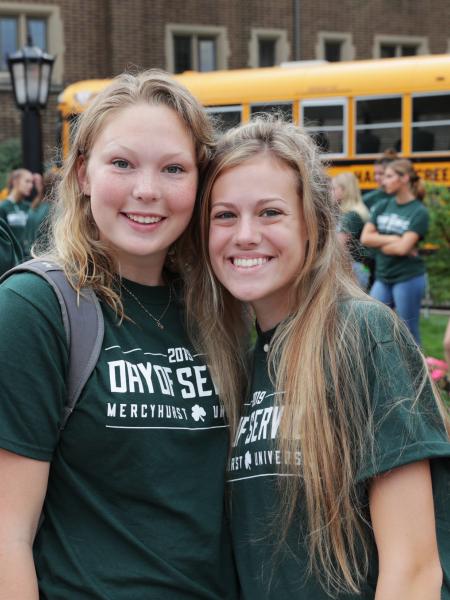 two female students pose outside