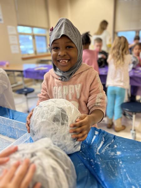 a child smiles with an art project