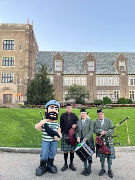 Luke with bagpipe players