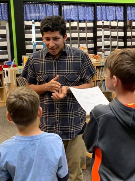 Teacher speaking with two students