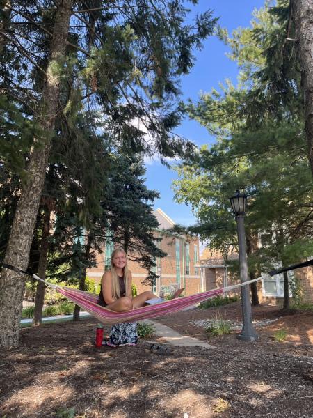 student sitting in hammock