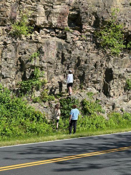 Geology students studying mountain side