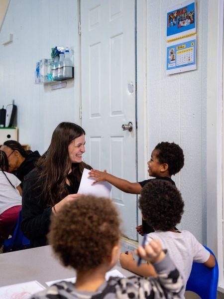 Student and child showing drawing