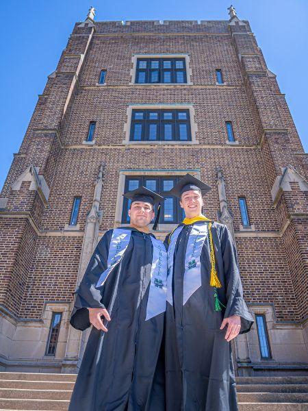 Graduation 2026 two male graduates in front of O'Neil Tower